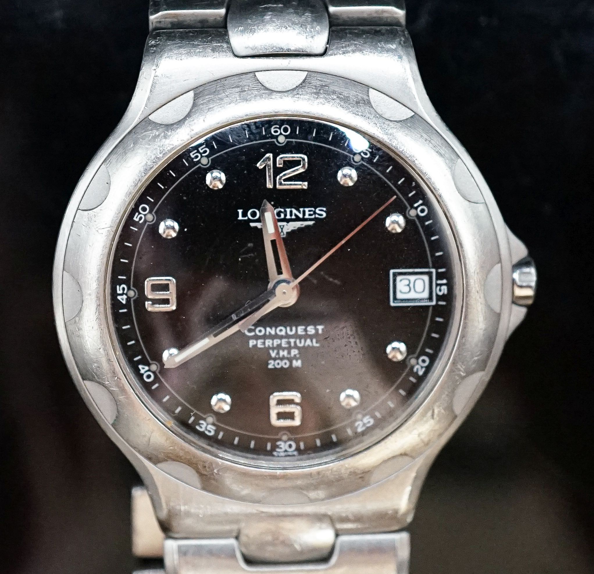 A gentleman's modern stainless steel Longines Conquest Perpetual V.H.P. wrist watch, on Longines stainless steel bracelet, case diameter 39mm.